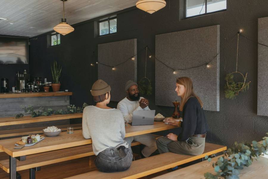 Colleagues discussing with each other at a table